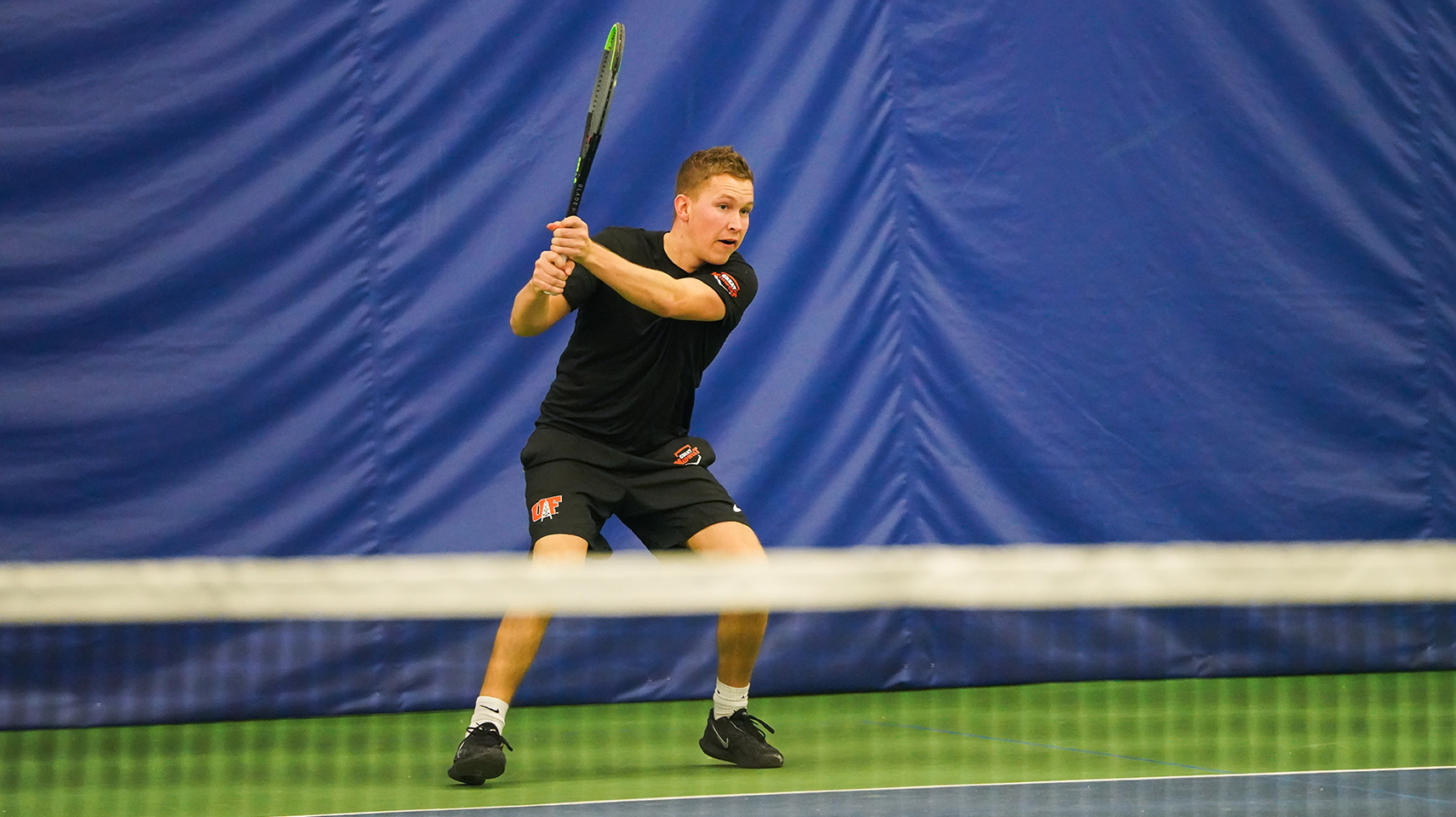 Men's tennis player with a backhand