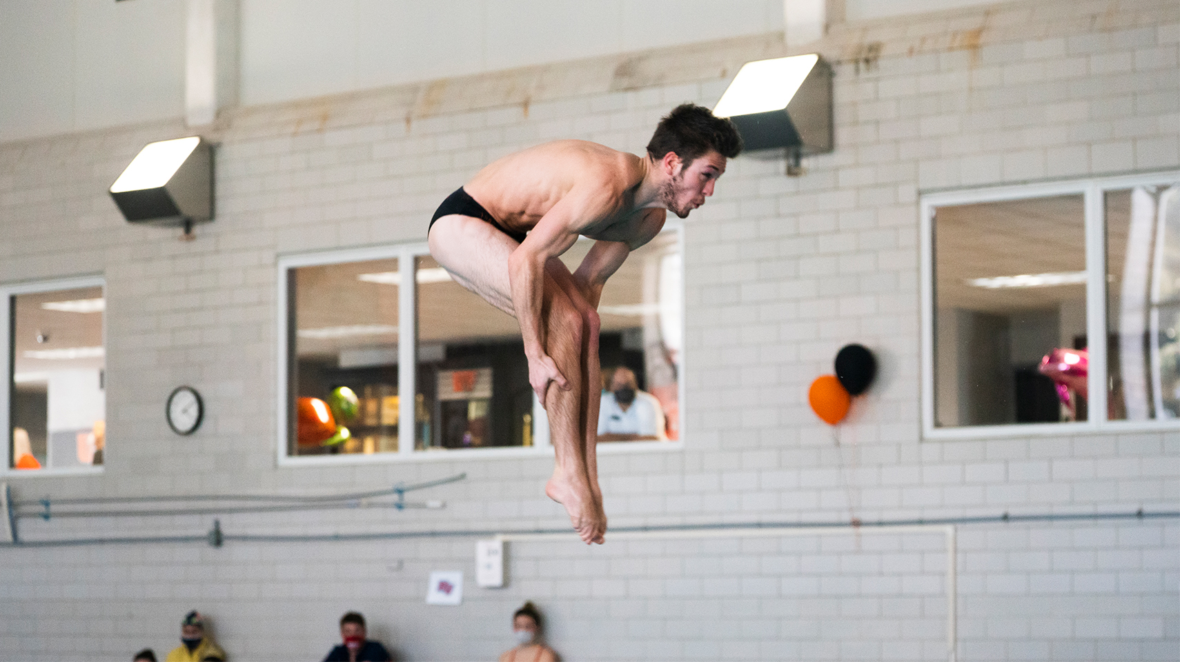 Men's diver at his highest point before dropping into the water