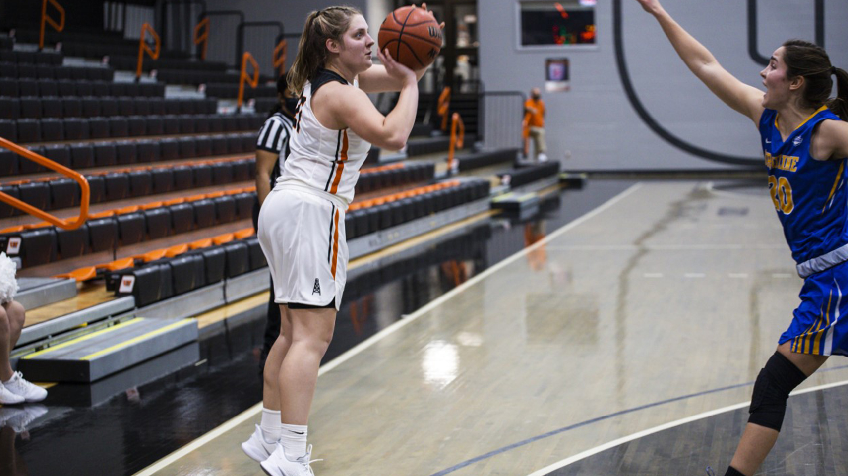 Women's basketball player shooting a three pointer