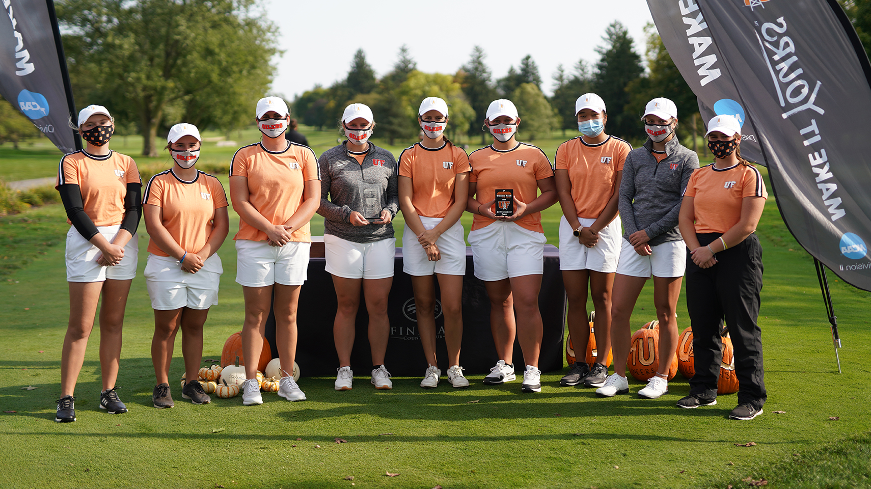 Women's Golf team with second place trophies.
