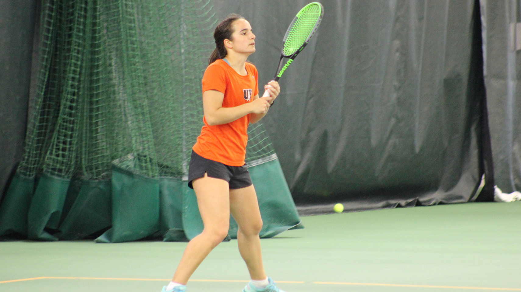 Women's tennis player in orange