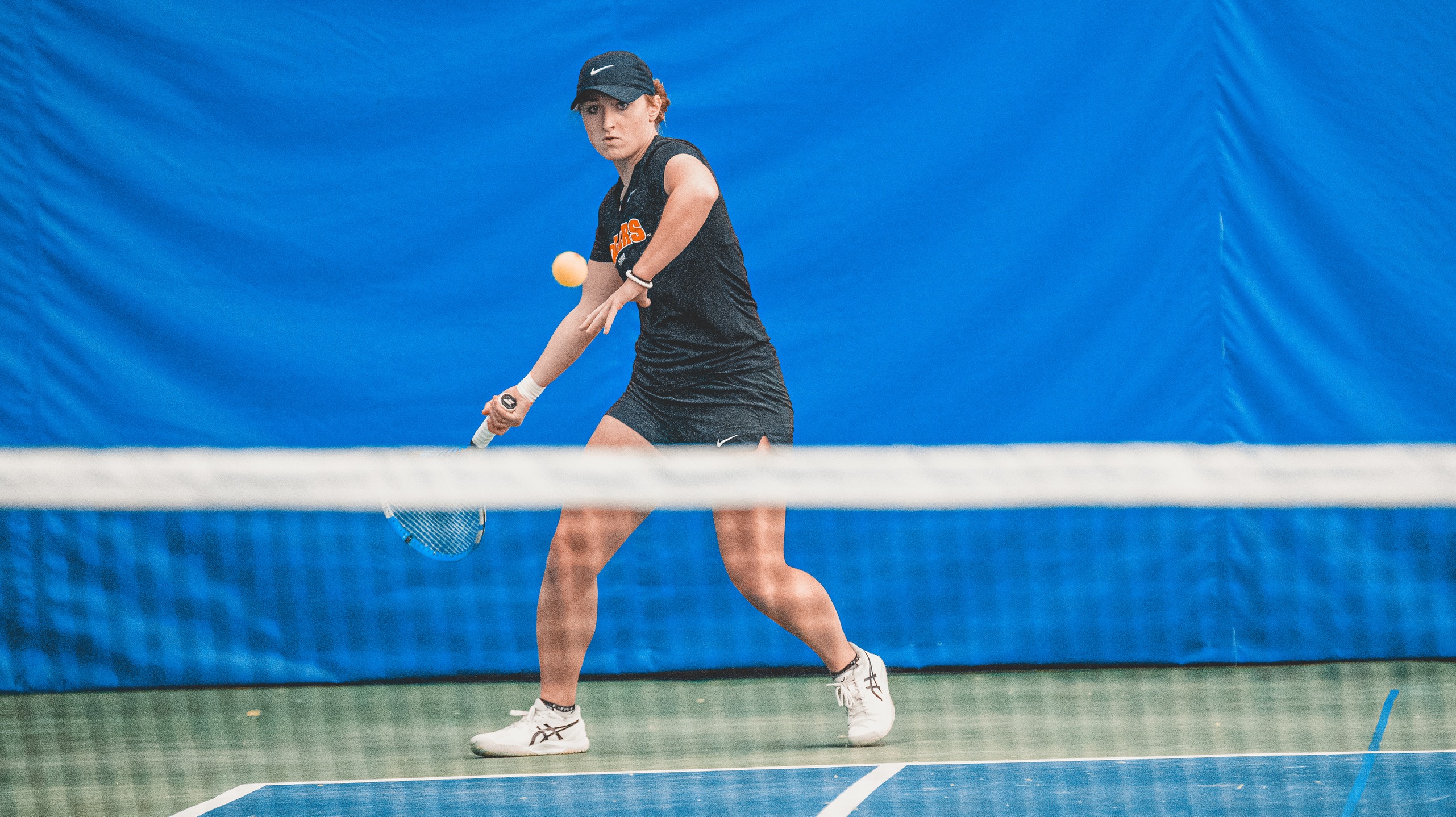 player in black playing tennis