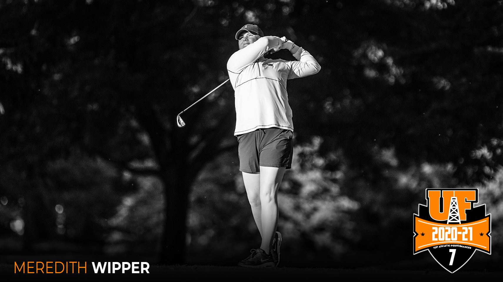 Women's golfer hitting behind trees
