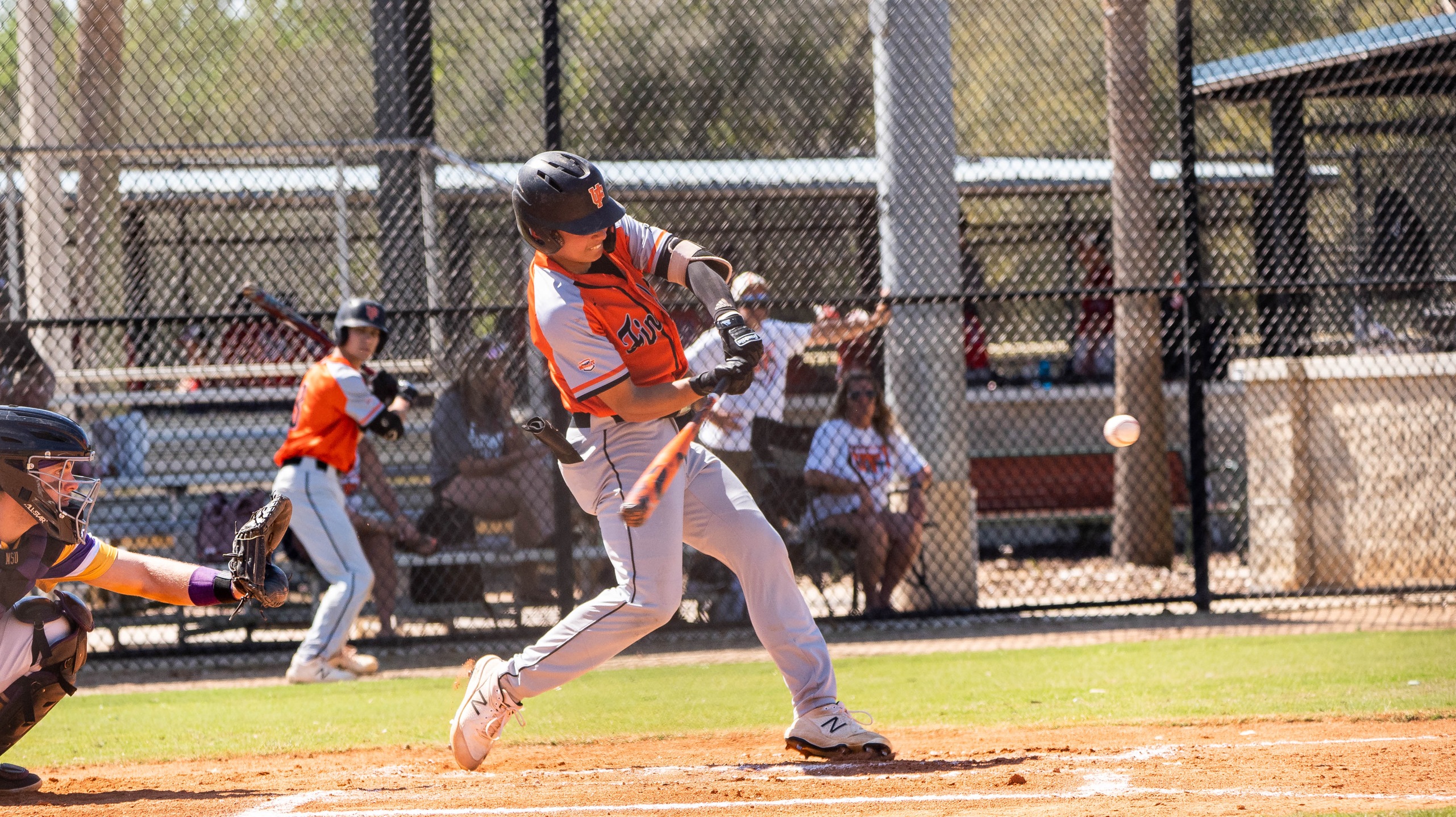 player in orange hitting ball 
