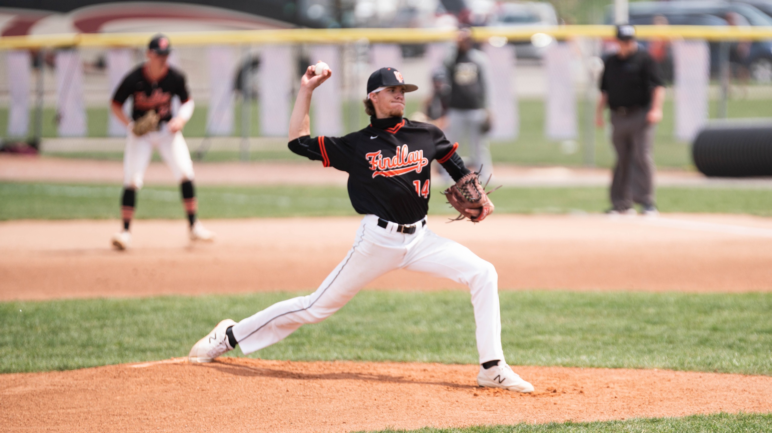 pitcher in black throwing 