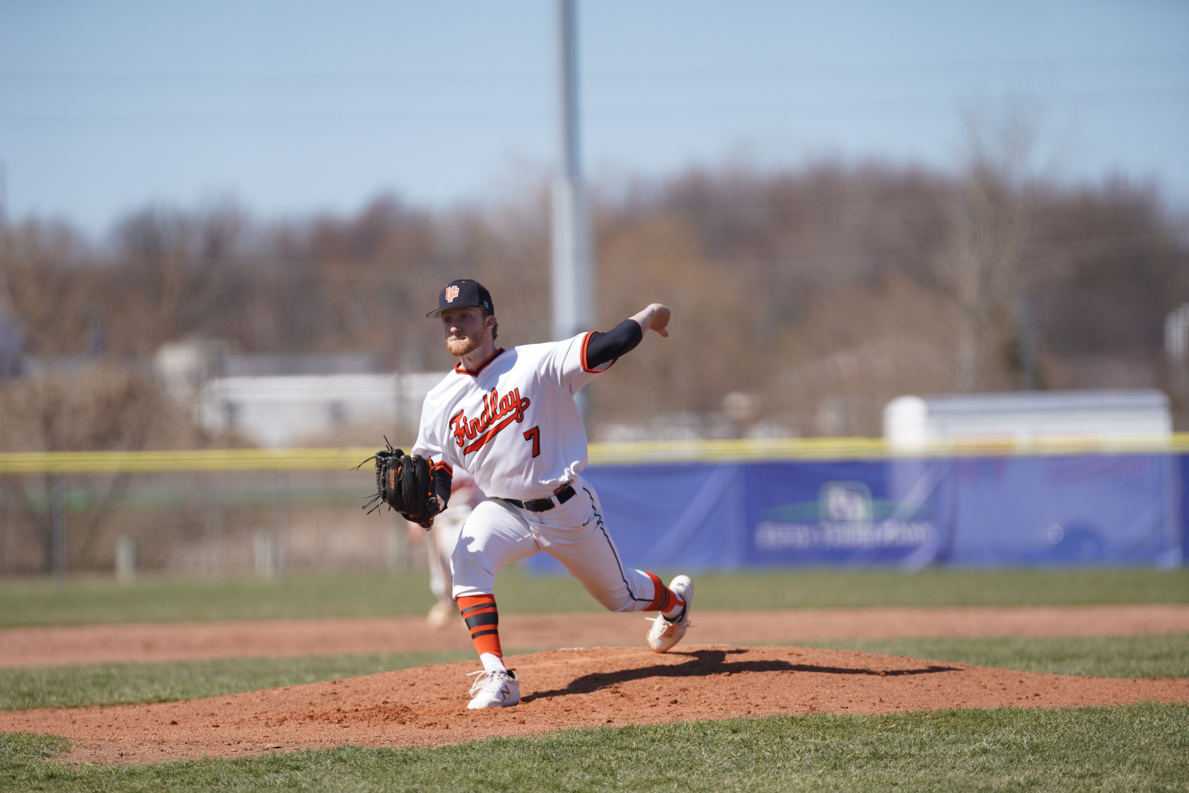 player in white pitching