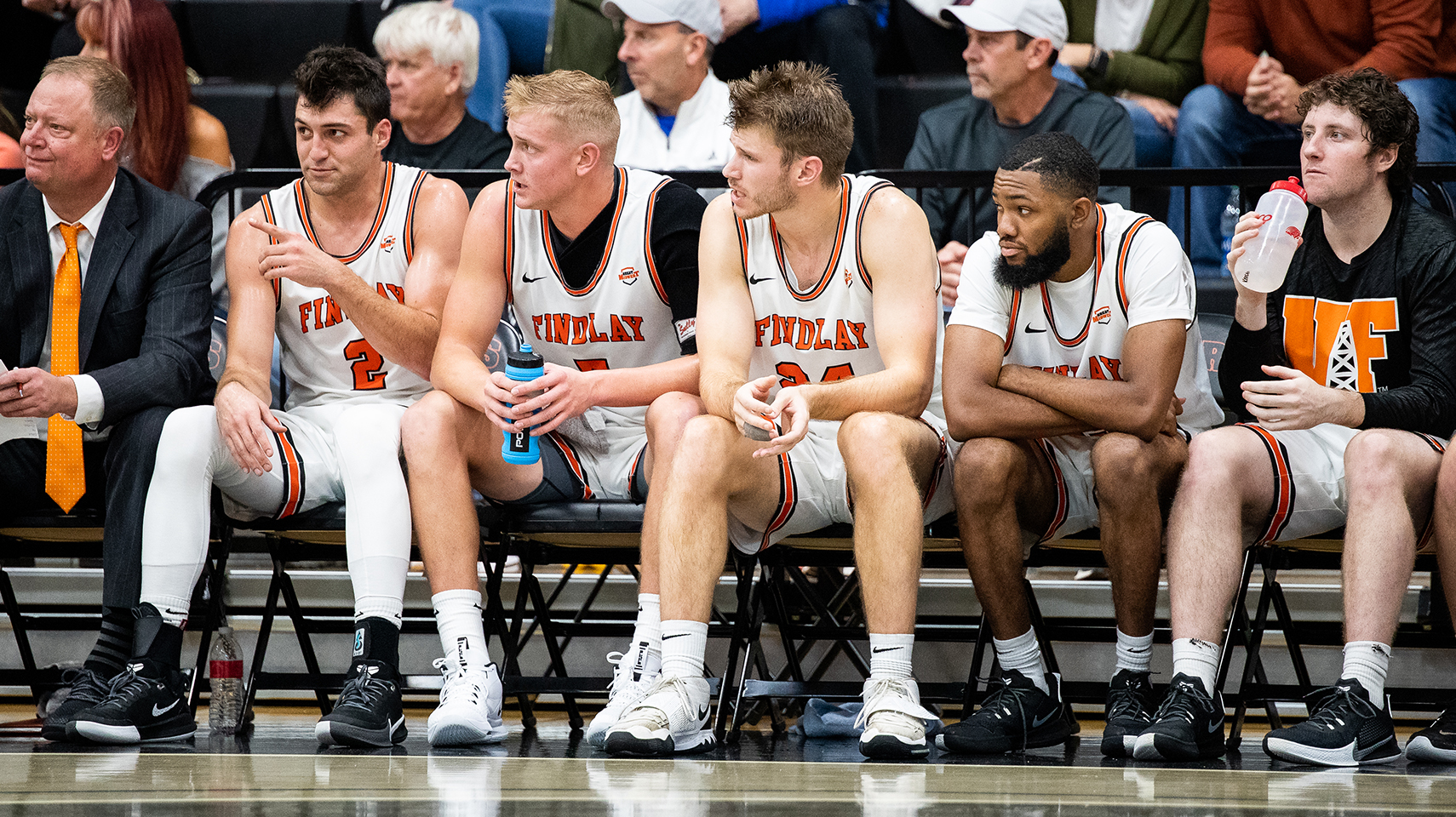 men's basketball players sitting on the bench