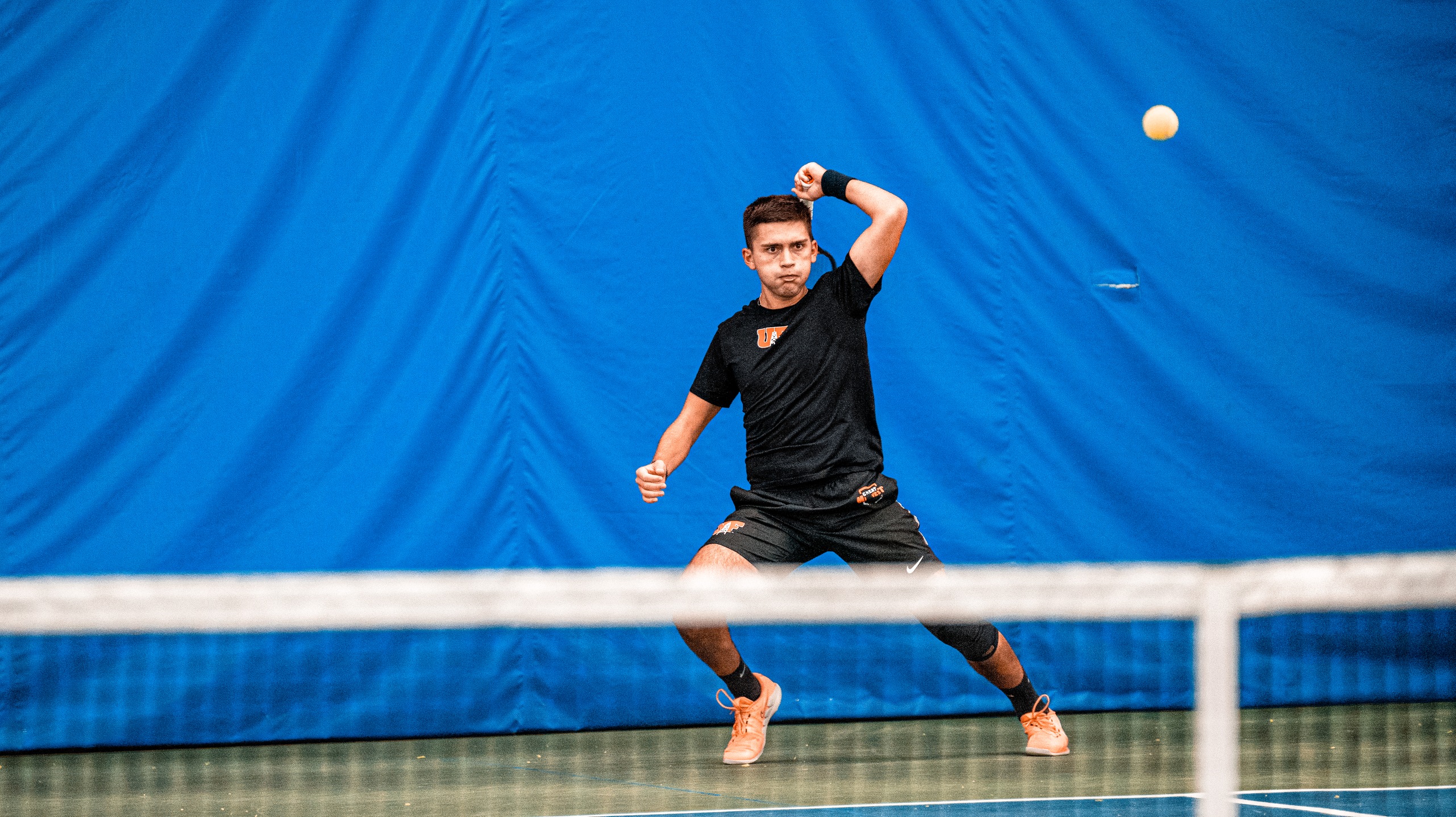 player in black playing tennis
