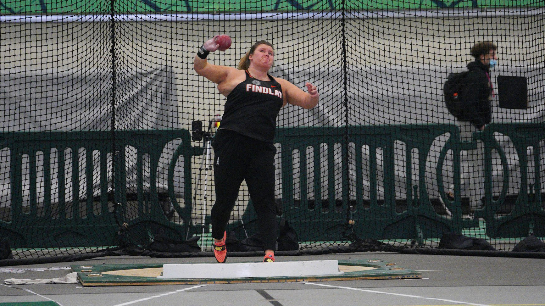 Thrower competes in shot put.