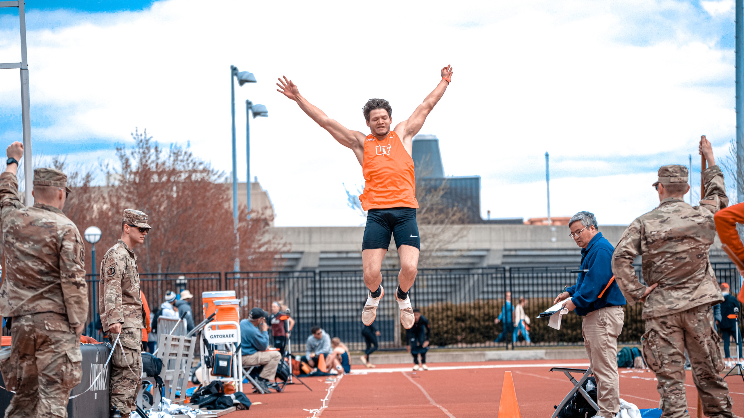 long jump guy in orange jumping