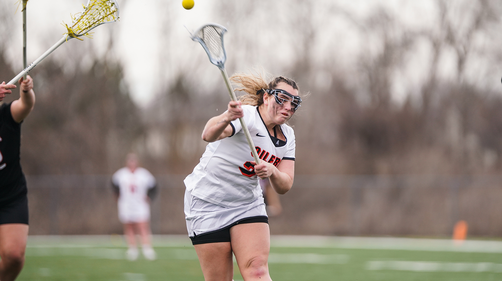 Women's lacrosse player taking a free position shot