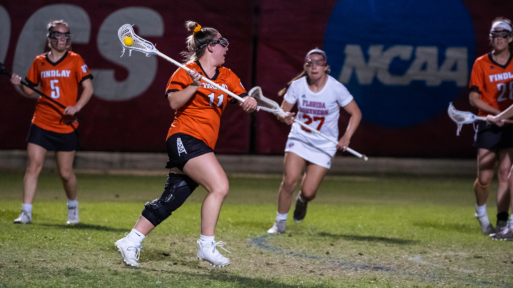 Women's lacrosse player running at night in Florida