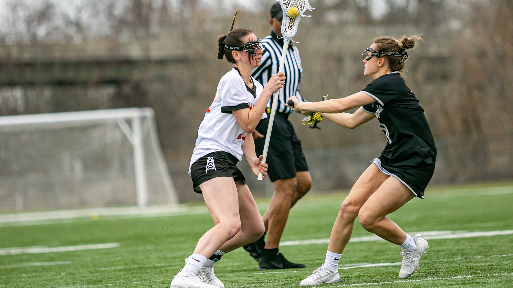 Women's lacrosse player standing up and changing directions