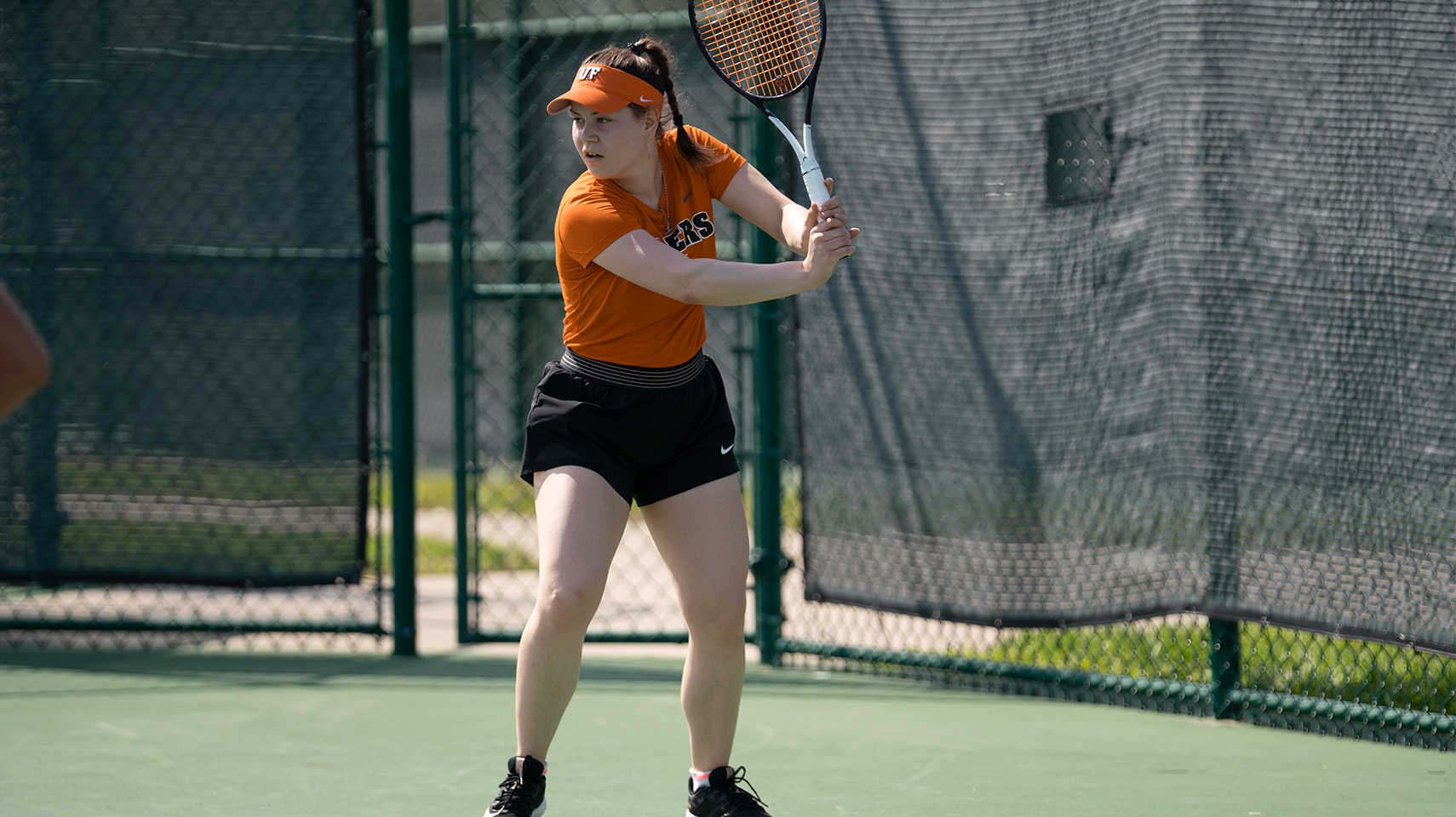 women's tennis player hitting the ball over the net at the G-MAC Championship