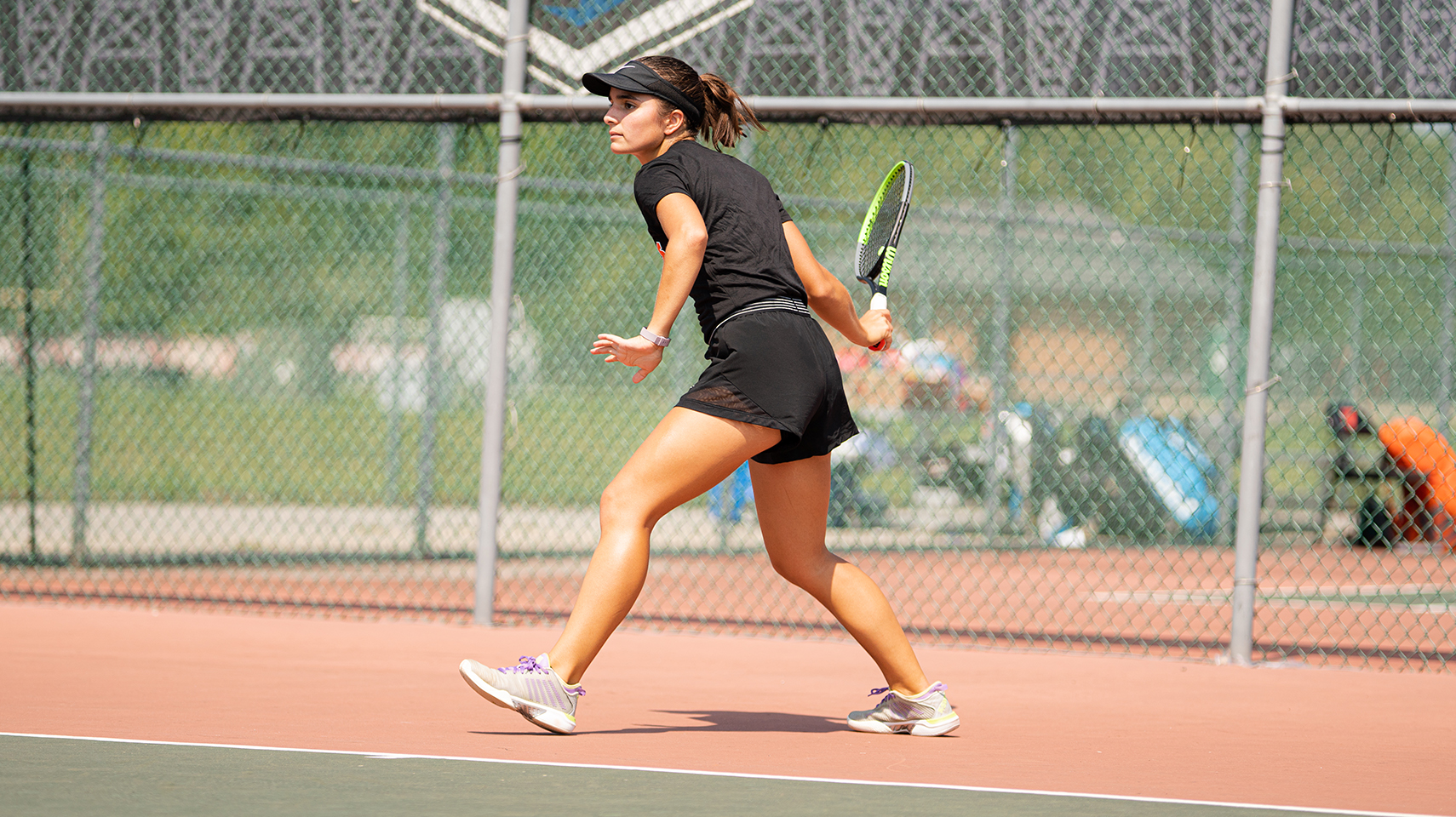 Women's tennis player hitting the ball in the sunshine