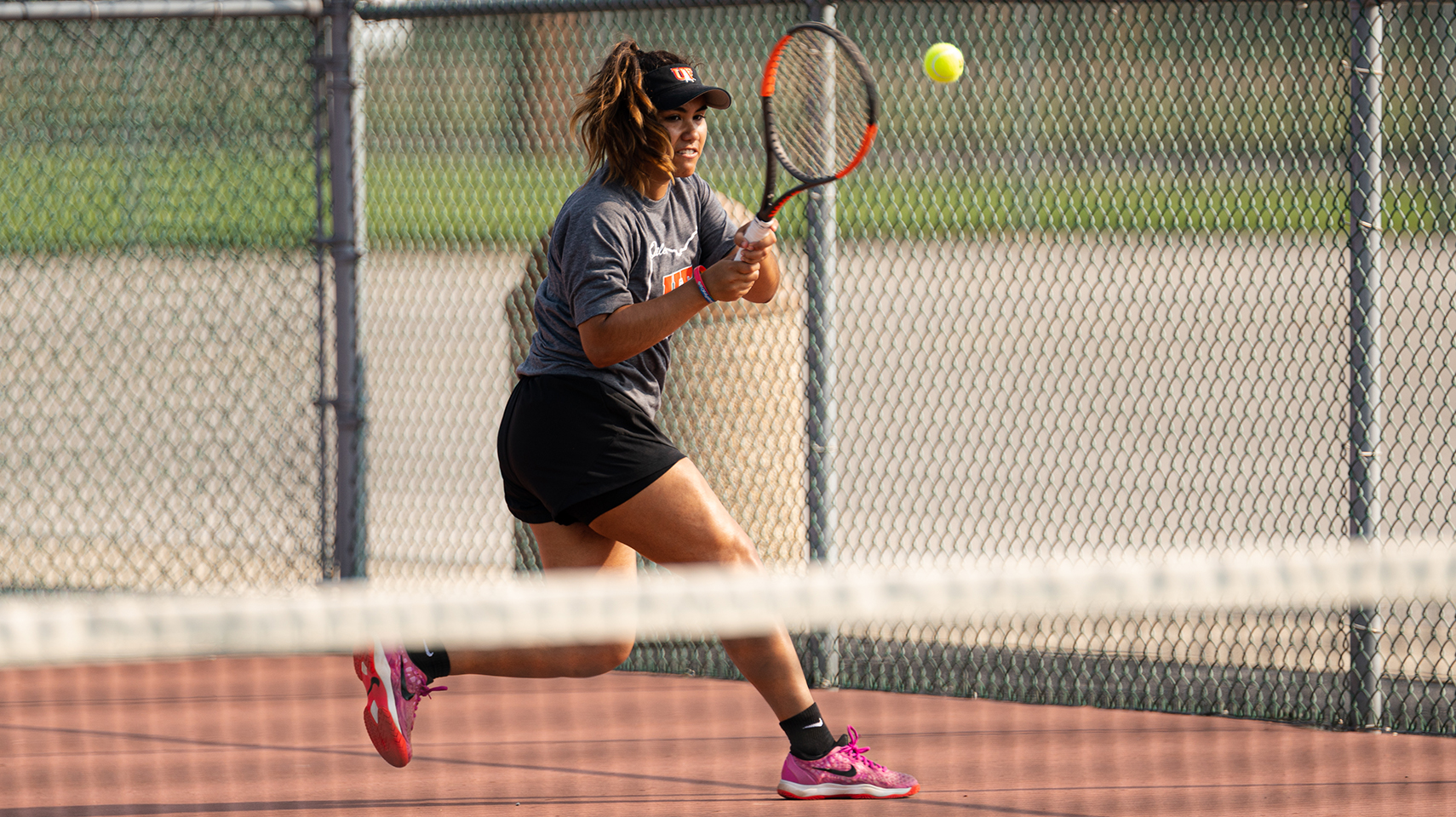Women's tennis player hitting the ball outside 